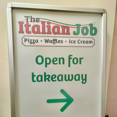 Sign with arrow pointing towards takeaway outlet